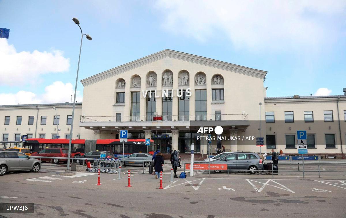 Travellers arrive at Vilnius Airport, in Lithuania, on March 14, 2020. Lithuanian airports started sanitary controls to limit the spread of the novel coronavirus. - AFP