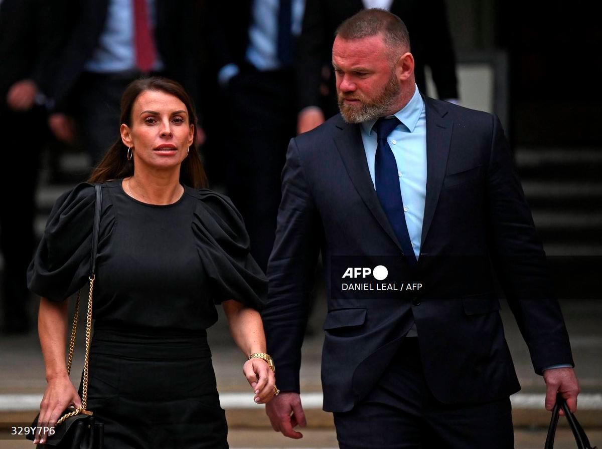 Coleen Rooney and her husband former England footballer Wayne Rooney, leave from the High Court in central London at the end of day three of the Wagatha Christie libel trial on May 12, 2022. - AFP