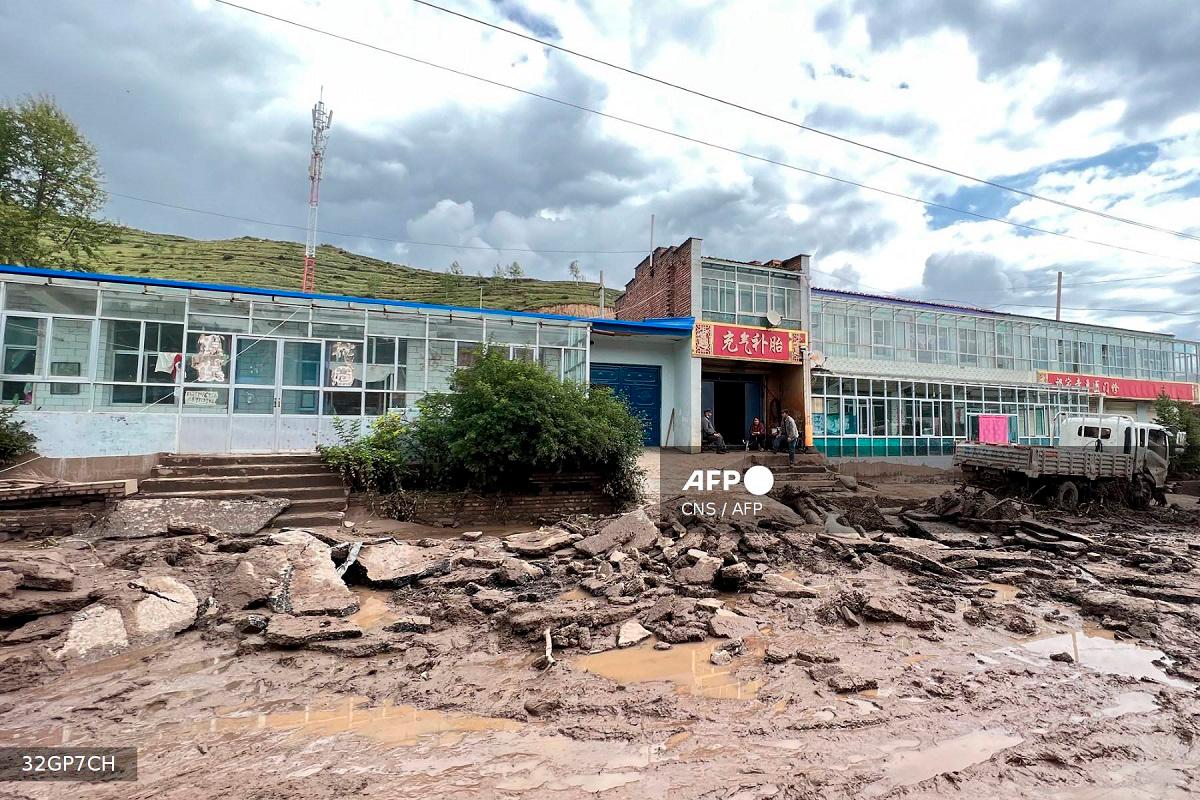 A road is damaged after a flash flooding caused by a sudden downpour triggered mudslides in Datong county, Xining city, in China’s northwestern Qinghai province on August 18, 2022. - CNS / AFP