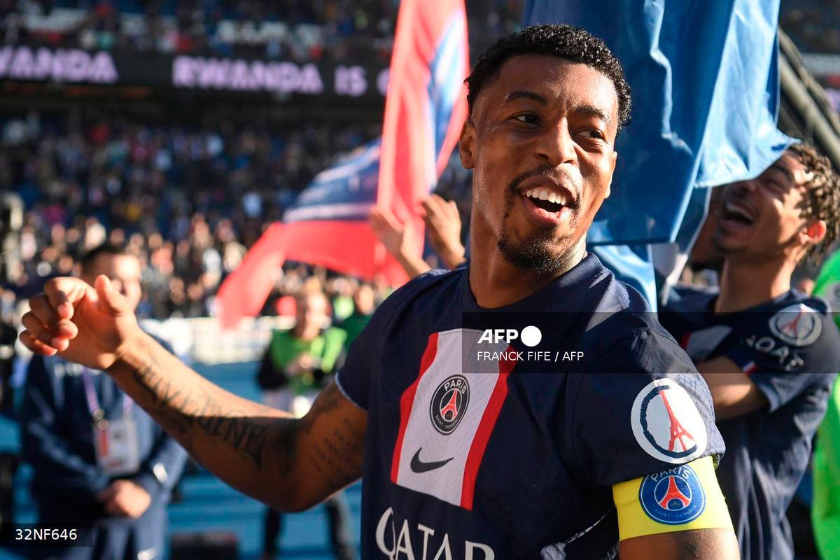 Paris Saint-Germain's French defender Presnel Kimpembe celebrates with supporters after the victory at the end of the French L1 football match between Paris Saint-Germain FC and AJ Auxerre at the Parc des Princes stadium in Paris on November 13, 2022. - AFP