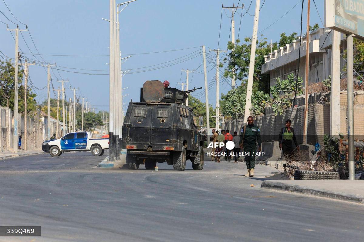 Security forces patrol outside a building which was attacked by suspected Al Shabaab militants in the Somalia’s capital Mogadishu, on February 21, 2023. (Photo by Hassan Ali ELMI / AFP)