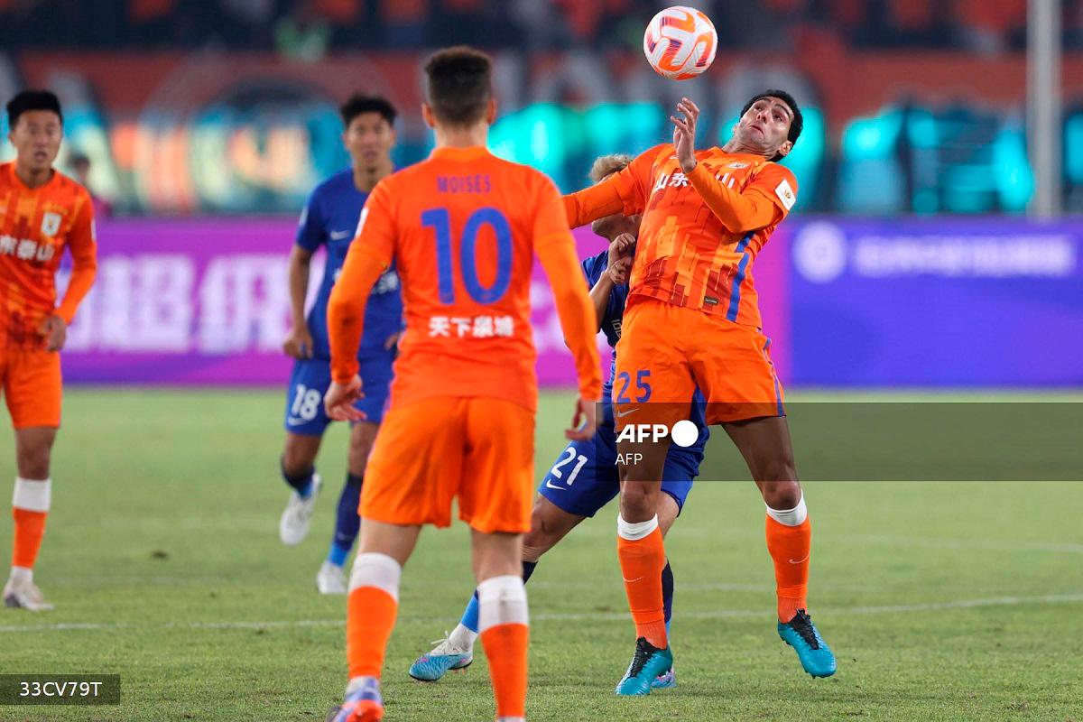 Shandong Taishan’s Marouane Fellaini (R) fights for the ball during their 2023 Chinese Football Association (CFA) Supercup football match with Wuhan Three Towns FC in Hangzhou. - AFPpix