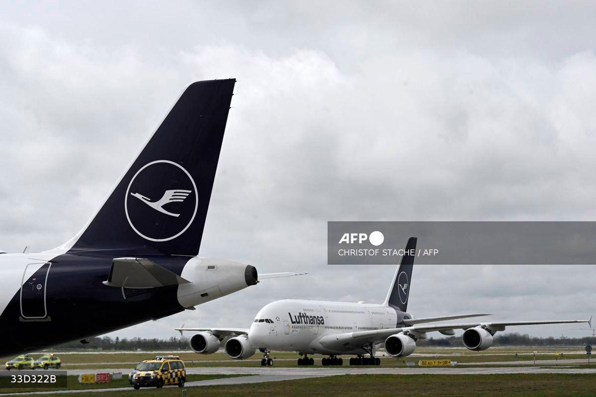 The logo of German airline Lufthansa is seen on the tail of the aircraft as a plane of the same airline lands at Munich International Airport, Munich, southern Germany on April 12, 2023. - AFP