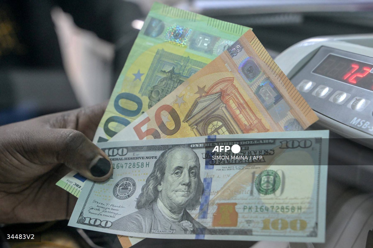 A teller displays US dollars and Euros at a money exchange market in Nairobi on November 20, 2023. - AFP