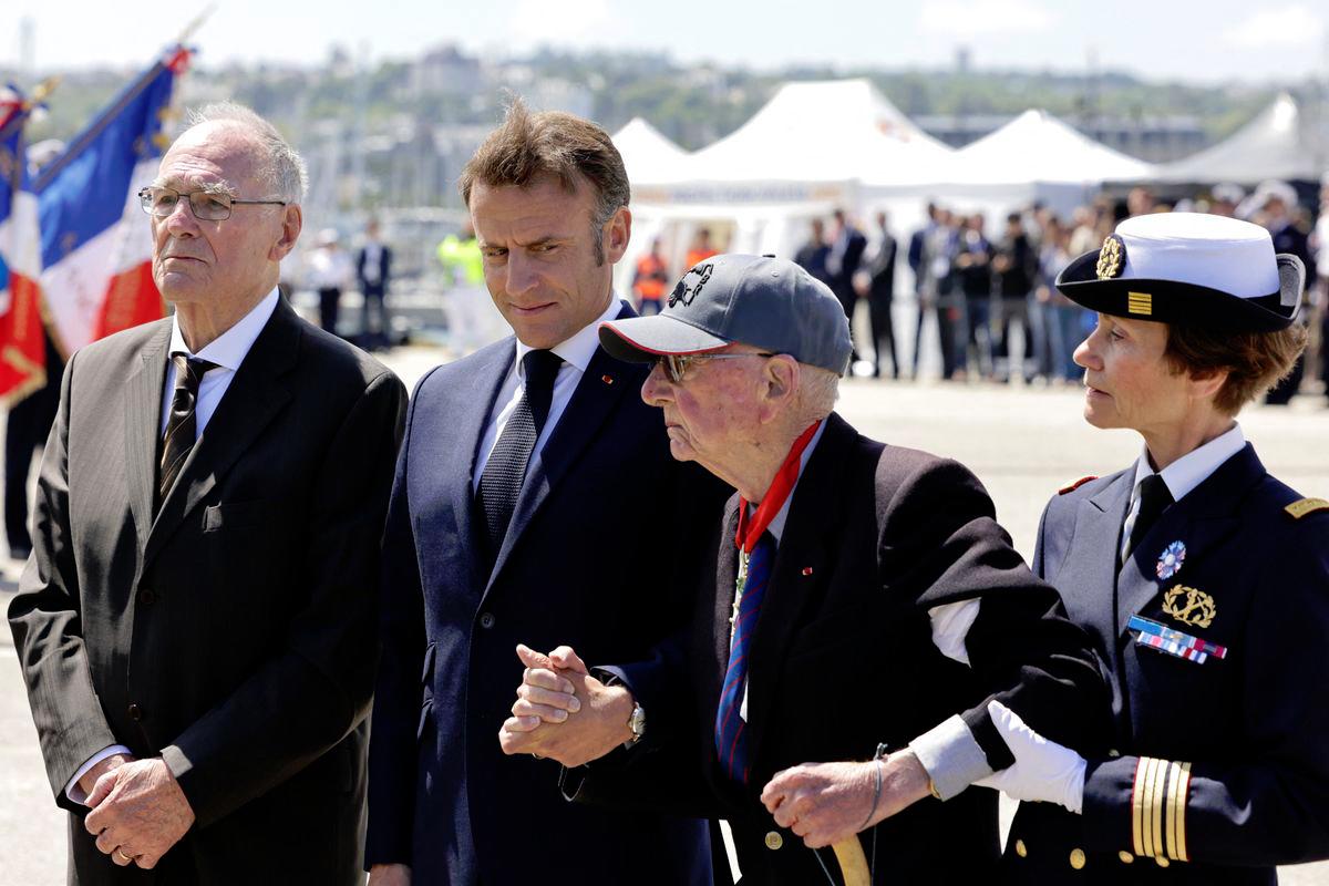 France’s President Emmanuel Macron (C), walks arm-in-arm with French WWII veteran Paul Leterrier (2nd R) attends a ceremony on Esplanade Paul Minard on June 7, 2024, as part of commemorations marking the 80th anniversary of the World War II “D-Day” Allied landings in Normandy - AFPpix
