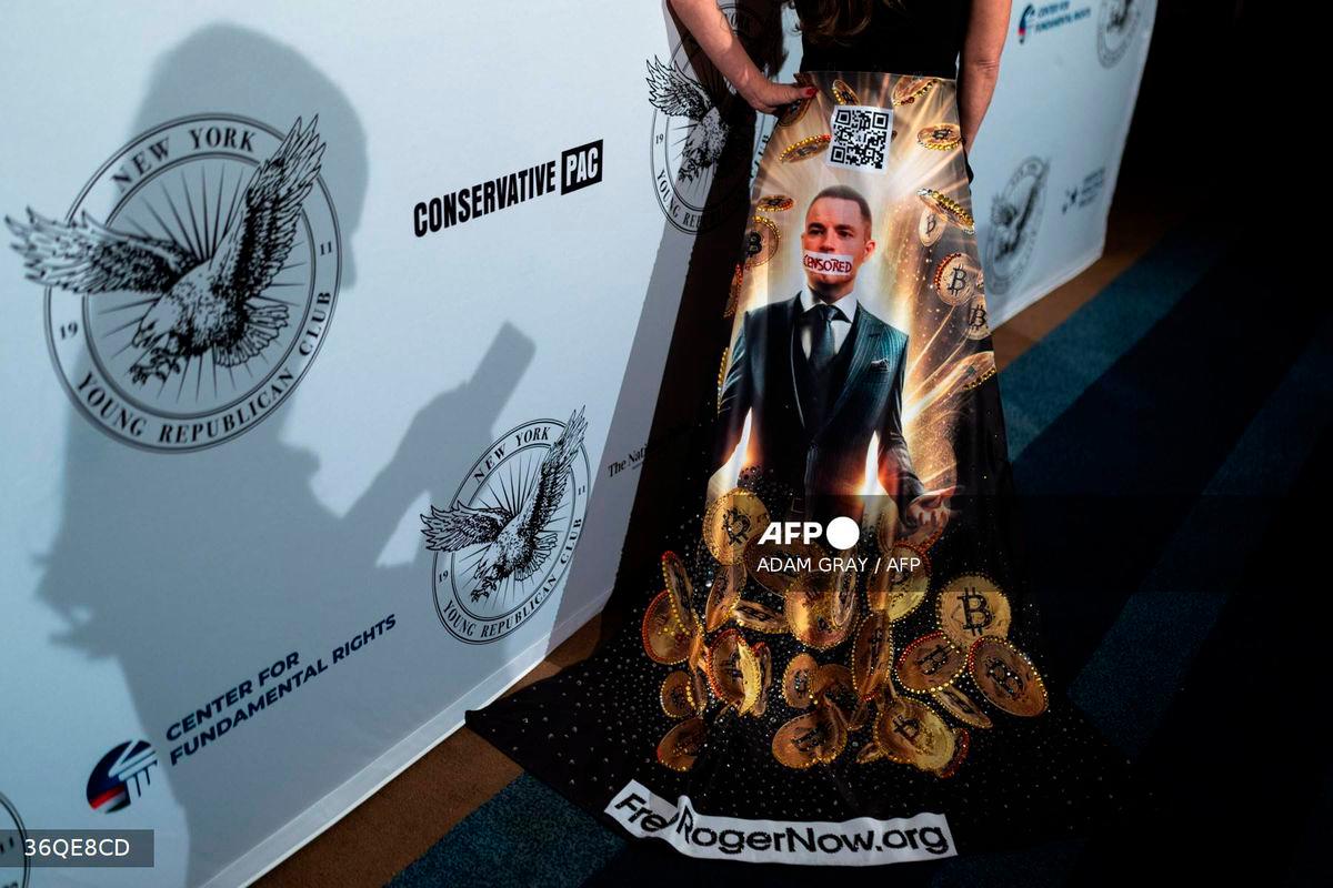 A person wears a dress with an image of Bitcoin investor Roger Ver at the New York Young Republican Club’s Annual Gala at Cipriani’s Wall Street in New York City. Photo by ADAM GRAY / AFP