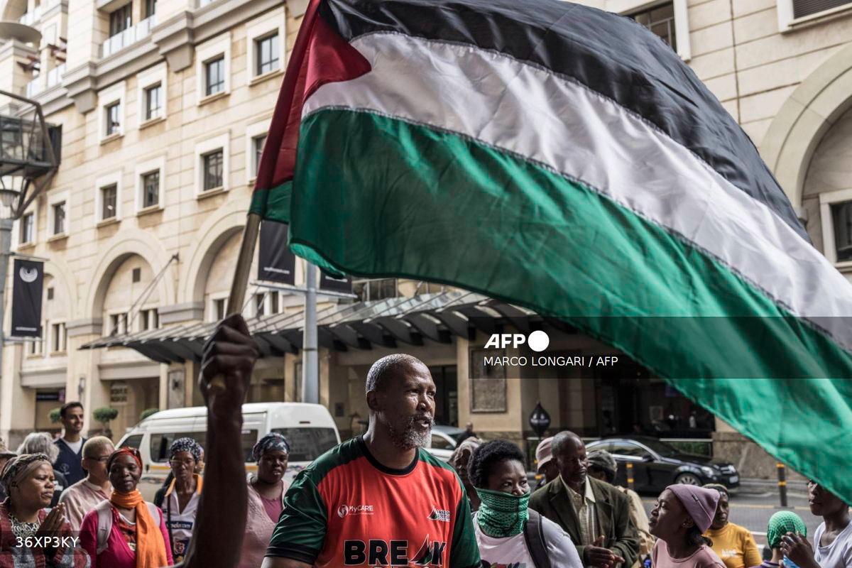 Mandla Mandela (C), a South African MP and the grandson of South African anti-apartheid hero Nelson Mandela, dances as he takes pat in a pro Palestinian demonstration outside the Sandton Convention Centre in Sandton, on February 13, 2025. - AFP