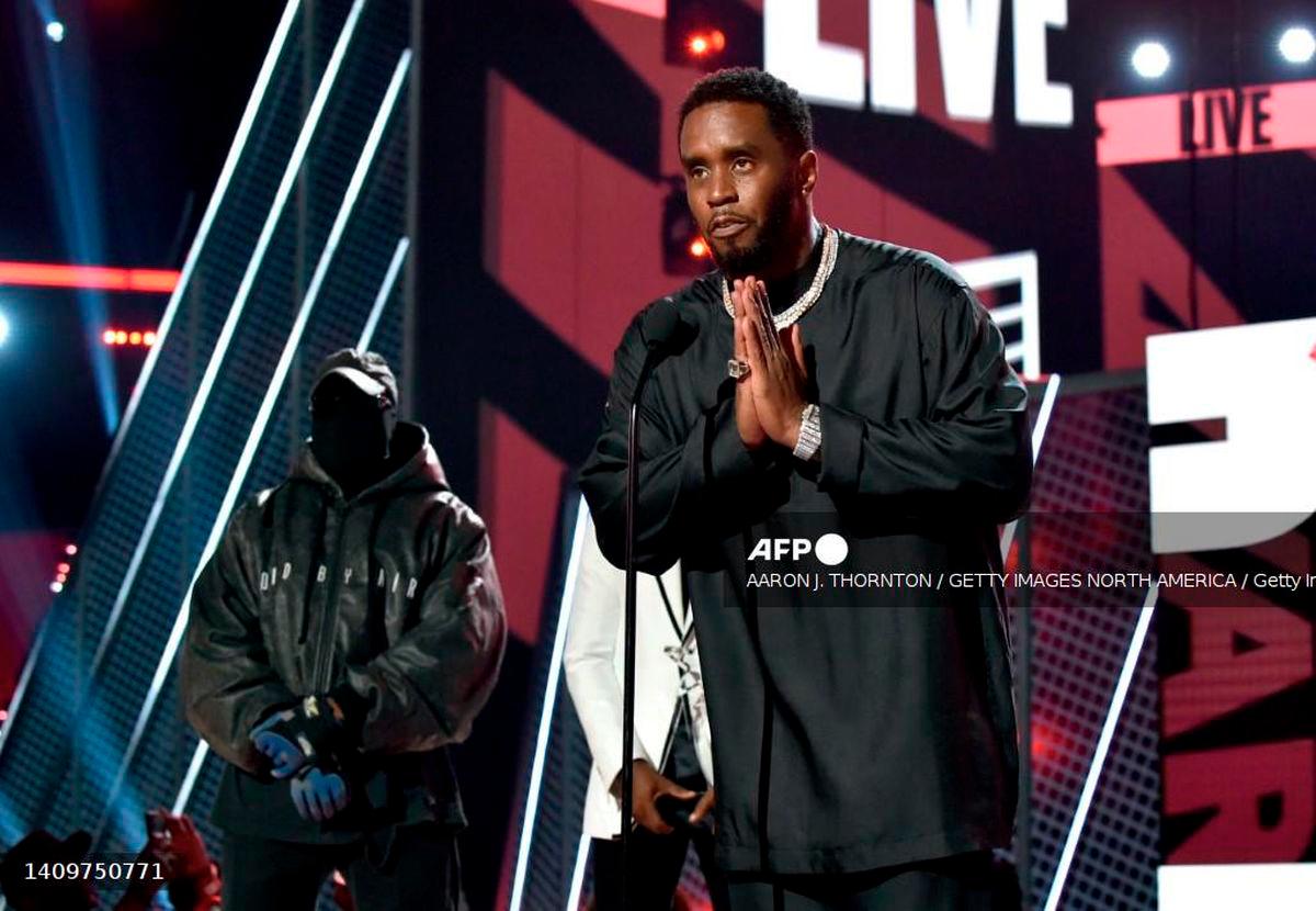 Honoree Sean 'Diddy' Combs (R) accepts the Lifetime Achievement Award presented by Coke from Kanye West and Babyface onstage during the 2022 BET Awards at Microsoft Theater on June 26, 2022 in Los Angeles, California. - Getty Images via AFP