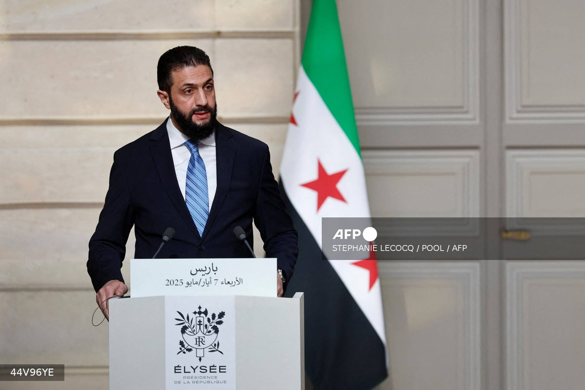 Syrian President Ahmed al-Sharaa speaks during a joint press conference with French President after a meeting at the Elysee Palace in Paris, on May 7, 2025. - POOL / AFP