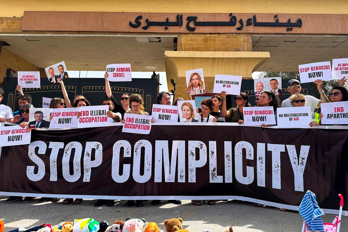 Italian and European parliament members hold placards during a protest in front of the Egyptian side of the Rafah border crossing, calling for an end to the war and for aid to be allowed into the Gaza Strip, on May 18, 2025. - AFPpix