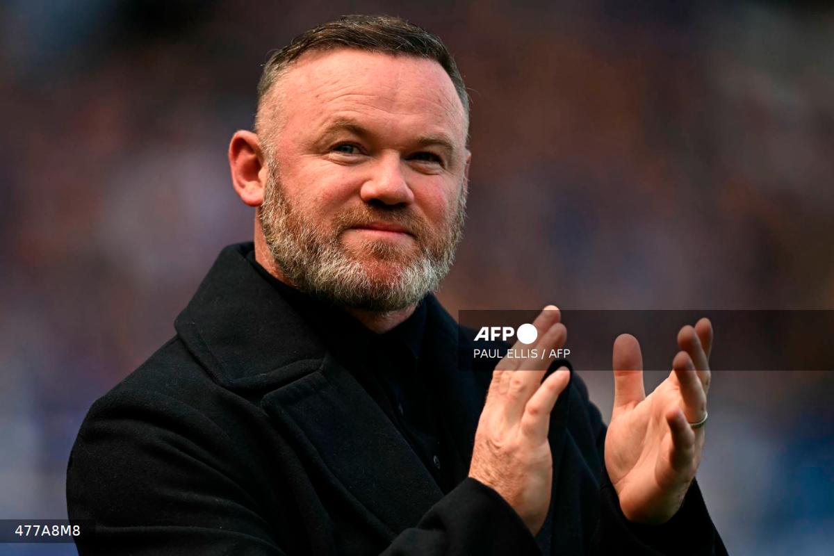 Former Everton player Wayne Rooney arrives on the pitch for the celebrations after the English Premier League football match between Everton and Southampton at Goodison Park in Liverpool, north west England on May 18, 2025, Everton's final premier league fixture played at the stadium, their home since 1892. - AFP