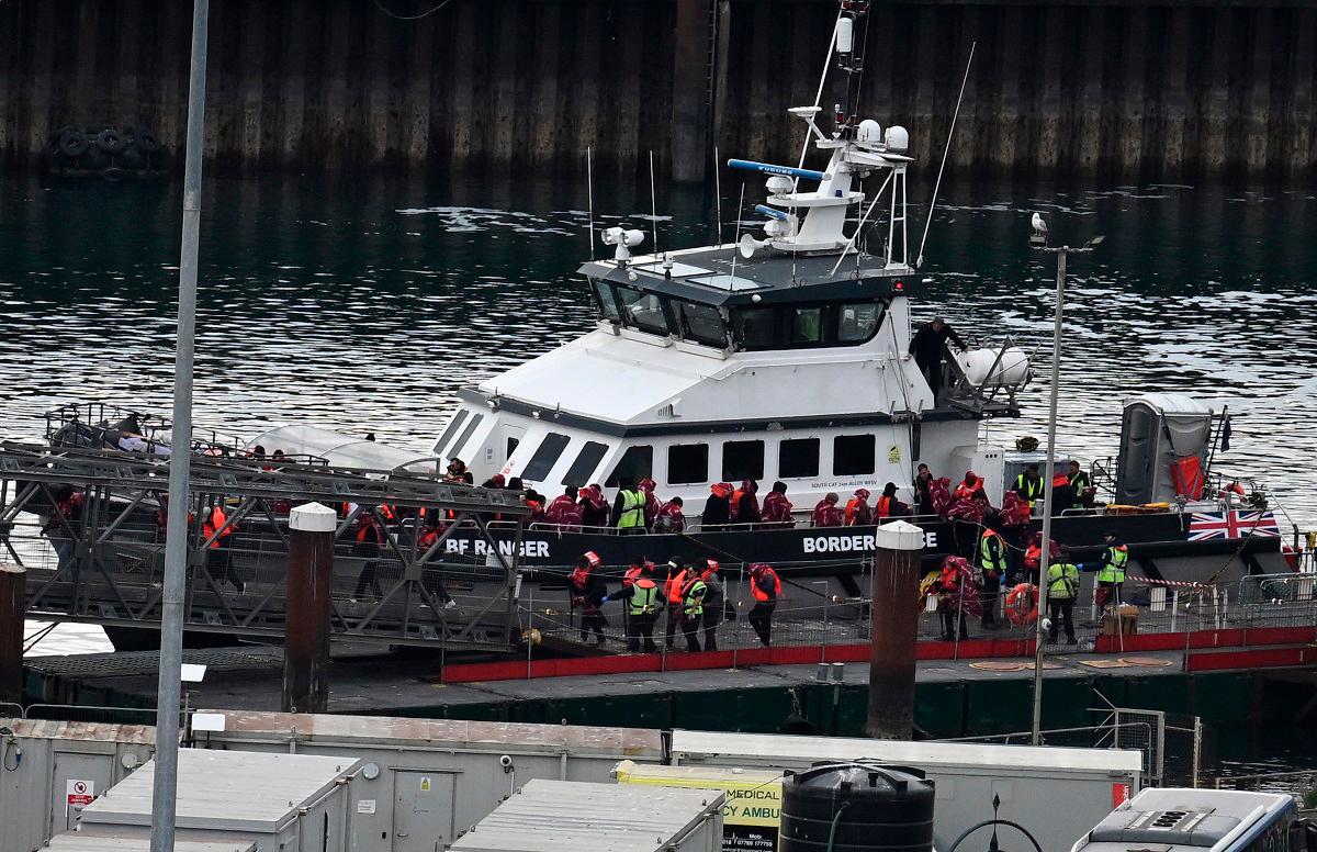 Migrants picked up at sea attempting to cross the English Channel from France, disembark from Border Force vessel 'Ranger' after it arrived at the Marina in Dover, south-east England, on May 21, 2025. - Ben STANSALL / AFP