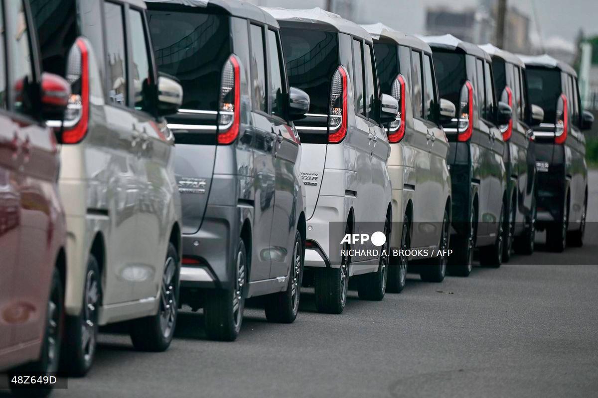 Vehicles sit lined up on a lot near the docks at the Port of Nagoya, Aichi prefecture on June 2, 2025. - AFP