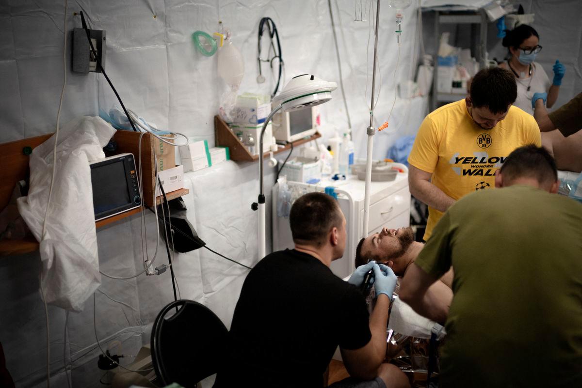 Ukrainian doctors treat a soldier injured by shrapnel from Russian explosive drones at a medical stabilisation centre of the 3rd Operational Brigade of the National Guard of Ukraine, in an undisclosed location near Pokrovsk, eastern Ukraine, on June 7, 2025, amid the Russian invasion of Ukraine.