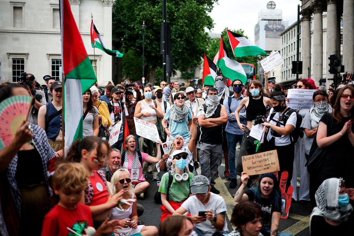 Protestors shout slogans and wave Palestinian flags as they rally in support of pro-Palestinian group Palestine Action after British government announced the group’s ban, in Trafalgar Square, in central London, on June 23, 2025. (Photo by HENRY NICHOLLS / AFP)