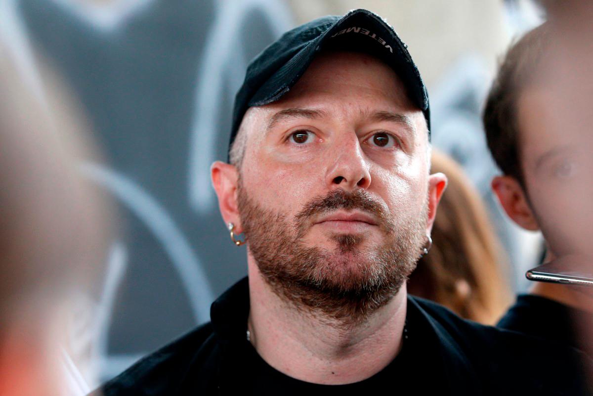 (FILES) Fashion designer for Vetements, Demna Gvasalia talks to people at the end of his men and women’s Spring/Summer 2019 collection fashion show, in Paris, on July 1, 2018. (Photo by GEOFFROY VAN DER HASSELT / AFP)