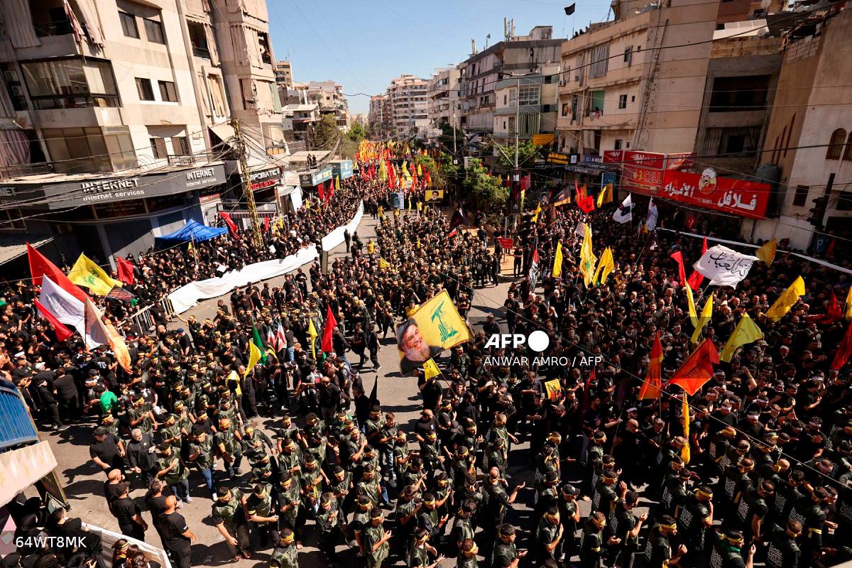 Lebanese Shiite Hezbollah supporters take part in a ceremony during the peak of Ashura, a 10-day period commemorating the seventh century killing of Prophet Mohammed’s grandson Imam Hussein, in Beirut’s southern suburbs on July 6, 2025. - ANWAR AMRO / AFP