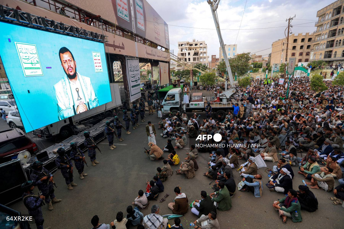 Yemeni Shiite Muslims listen to a speech by Huthi leader Abdul-Malik al-Huthi broadcast on a giant screen during a ceremony commemorating Ashura, a ten-day period to remember and mourn the seventh century killing of Islam’s Prophet Mohammed’s grandson Imam Hussein, in Sanaa, on July 6, 2025. - AFP