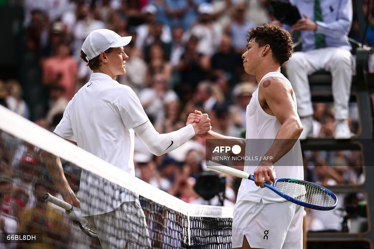 Winner Italy’s Jannik Sinner shakes hands with US player Ben Shelton at the end of their men’s singles quarter-final tennis match on the tenth day of the 2025 Wimbledon Championships at The All England Lawn Tennis and Croquet Club in Wimbledon, southwest London, on July 9, 2025. - AFP