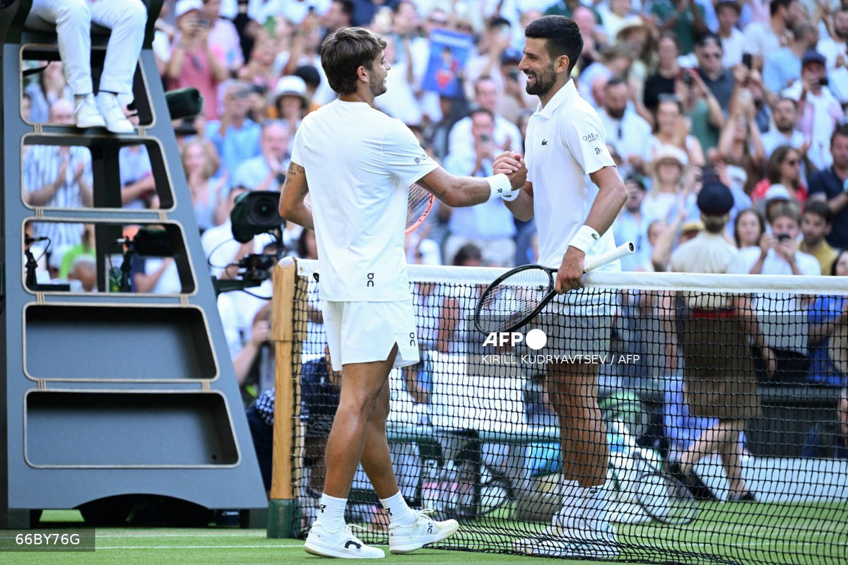 Serbia’s Novak Djokovic shakes hands with Italy’s Flavio Cobolli after winning during their men’s singles quarter-final tennis match on the tenth day of the 2025 Wimbledon Championships at The All England Lawn Tennis and Croquet Club in Wimbledon, southwest London, on July 9, 2025. - AFP