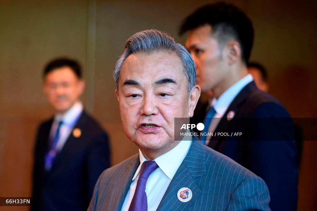 China's Foreign Minister Wang Yi speaks to the media as he walks between meetings during the 58th ASEAN Foreign Ministers’ meeting and related meetings at the Convention Centre in Kuala Lumpur on July 11, 2025. - POOL via AFP