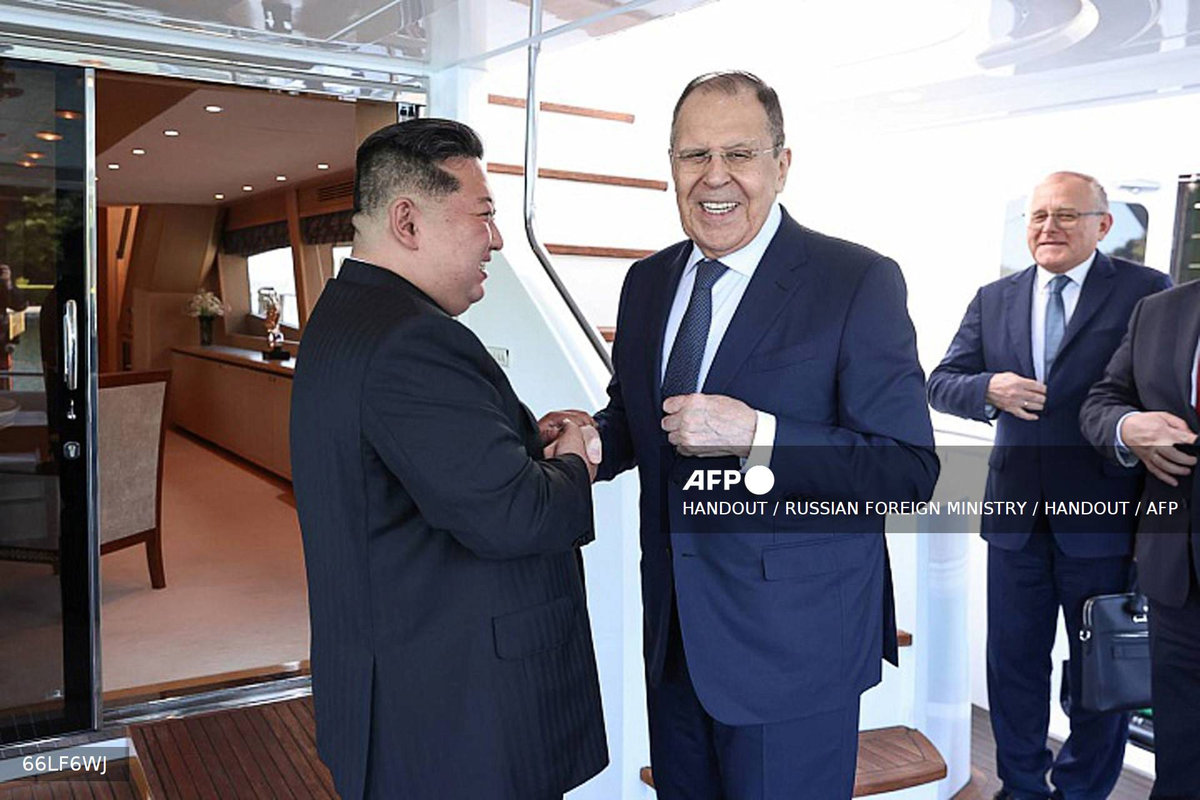 This handout photograph released by the Russian Foreign Ministry shows Russian Foreign Minister Sergei Lavrov (C) shaking hands with North Korean leader Kim Jong Un (L) in Wonsan on July 12, 2025. Russian Foreign Minister Lavrov on July 12, 2025 met with North Korean leader Kim Jong Un during his visit to the secretive country and key Moscow ally, Russia’s foreign ministry said. (Photo by Handout / RUSSIAN FOREIGN MINISTRY / HANDOUT) - AFP