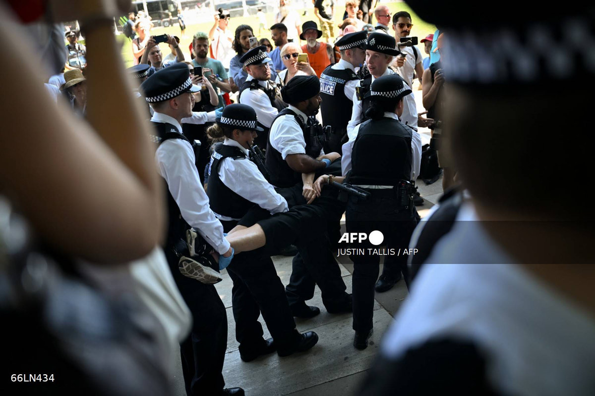 A protester is carried away after being arrested as people gather in support of the pro-palestinian group “Palestine Action”, in Parliament Square, London on July 12, 2025, following the Home Secretary’s decision to proscribe the group under anti-terror laws. - AFP