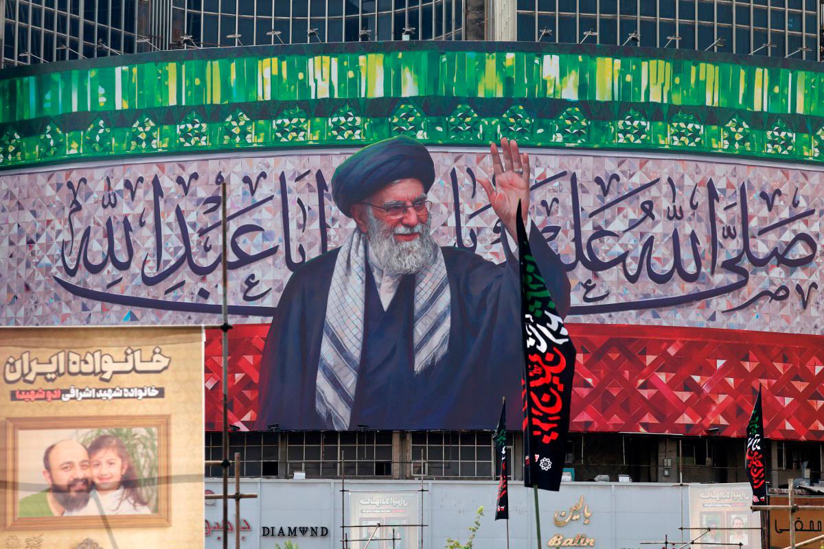 A billboard depicting Iran’s Supreme Leader Ayatollah Ali Khamenei is displayed in the centre of Tehran’s Valiasr Square on July 13, 2025. (Photo by ATTA KENARE / AFP)