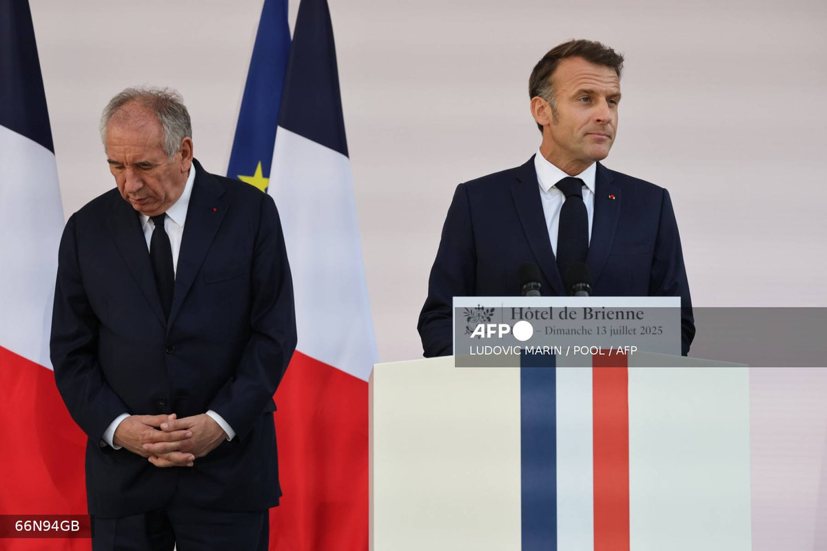 France’s Prime Minister Francois Bayrou (L) looks on as France’s President Emmanuel Macron delivers a speech to army leaders at l’Hôtel de Brienne in Paris on July 13, 2025, on the eve of the annual Bastille Day Parade in the French capital. - AFP
