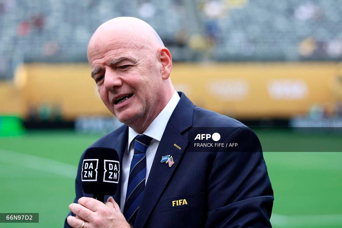 FIFA President Gianni Infantino speaks to the media on the pitch before the FIFA Club World Cup 2025 final football match between England's Chelsea and France's Paris Saint-Germain at the MetLife Stadium in East Rutherford, New Jersey on July 13, 2025. - AFP