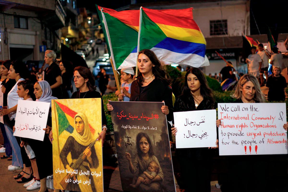 Members of the Druze community in the Israel-annexed Golan Heights gather for a rally in solidarity with the Druze community in Syria in the village of Majdal Shams in the Golan on July 19, 2025. - AFP