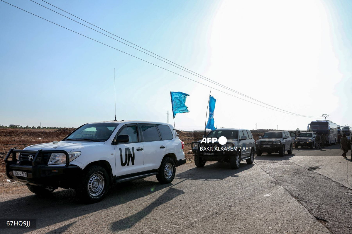 A United Nations convoy evacuating families from Sweida moves through the buffer zone in Busra al-Harir in Syria's southern Daraa province on July 22, 2025. - AFP