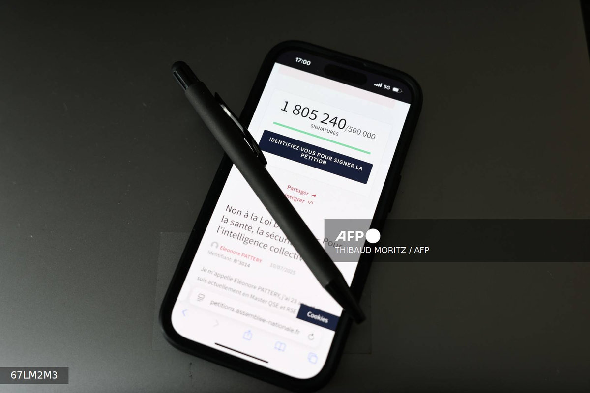 This photograph, taken on July 23, 2025 in Paris, shows a pen and a smart-phone screen displaying the French National Assembly website showing the number of citizens who had signed the petition against the Duplomb law “Non à la loi Duplomb - pour la santé, la sécurité, l'intelligence collective” (No to the Duplomb law - for health, safety and collective intelligence). - AFP