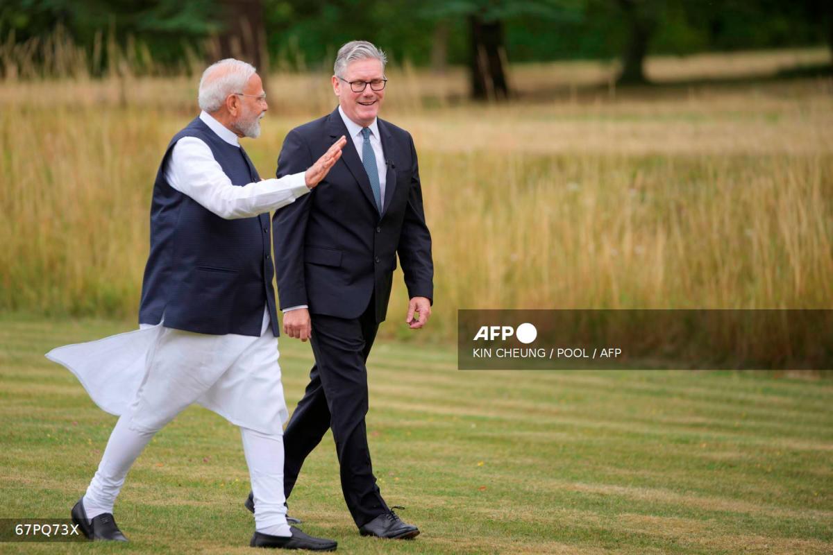 Britain's Prime Minister Keir Starmer (R) and India's Prime Minister Narendra Modi (L) speak as they walk in the gardens of Chequers, in Aylesbury, England, on July 24, 2025. - POOL via AFP
