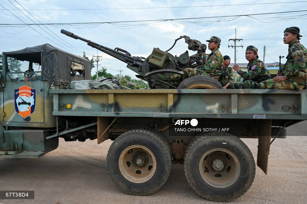 Cambodian soldiers stand on a military truck with an anti-aircraft gun in Oddar Meanchey province on July 25, 2025. - AFP