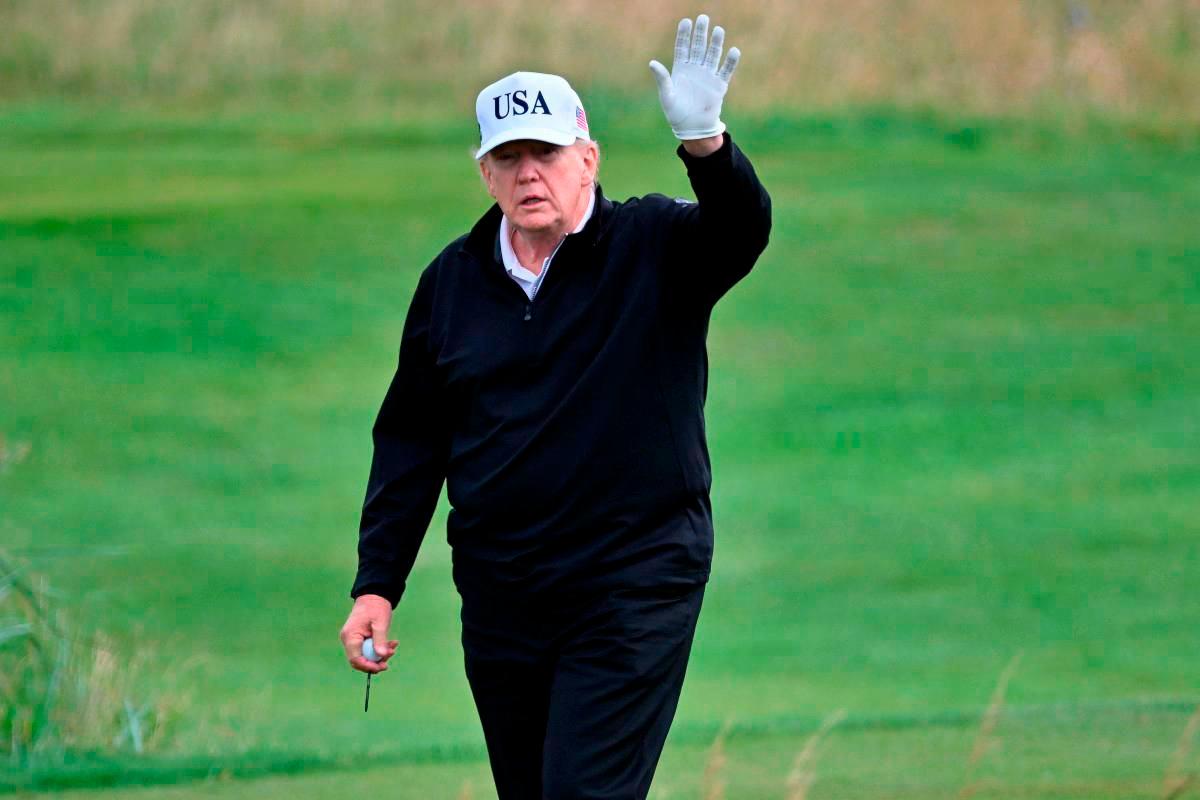 US President Donald Trump reacts as he plays golf at the Trump Turnberry Golf Courses, in Turnberry on the south west coast of Scotland on July 26, 2025 - AFP