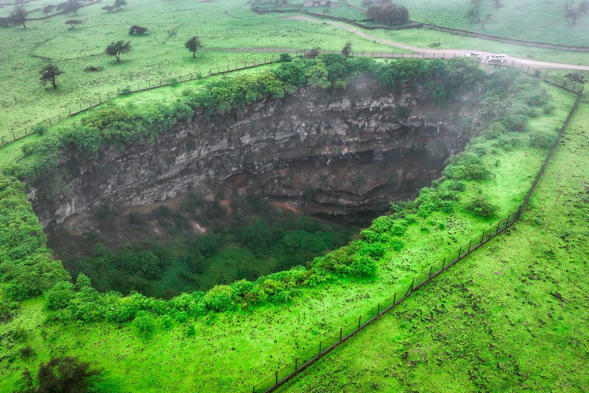 An aerial picture shows a view of the Sheeheet sinkhole in Oman’s Dhofar region near the city of Taqah on July 25, 2025. (Photo by AFP)
