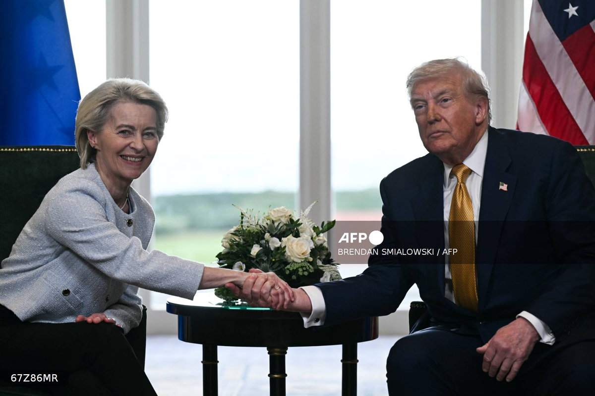 US President Donald Trump (R) shakes hands with European Commission President Ursula von der Leyen (L) after agreeing on a trade deal between the two economies following their meeting, in Turnberry south west Scotland on July 27, 2025, on the third day of his visit to the country, since his second tenure as President began. - AFP