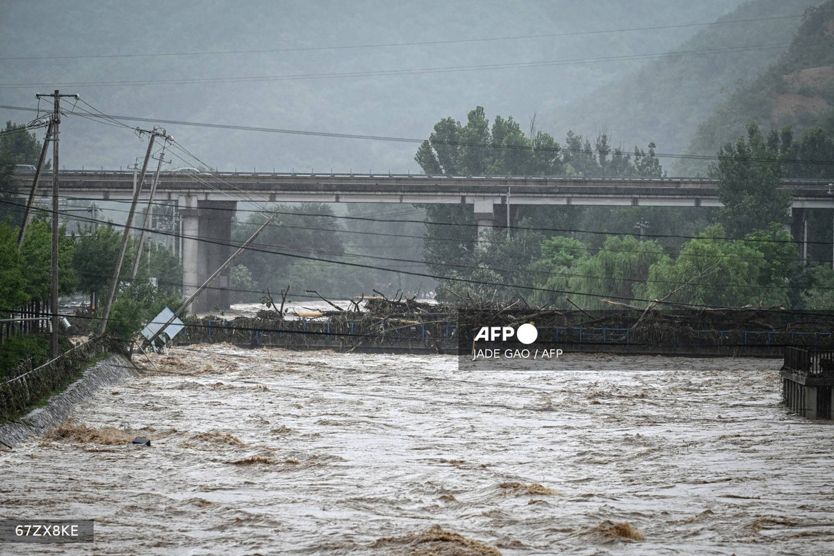 A flooded area is seen after heavy rains at Xin'anzhuang village, in Miyun district, on the outskirts of Beijing on July 28, 2025. - AFP
