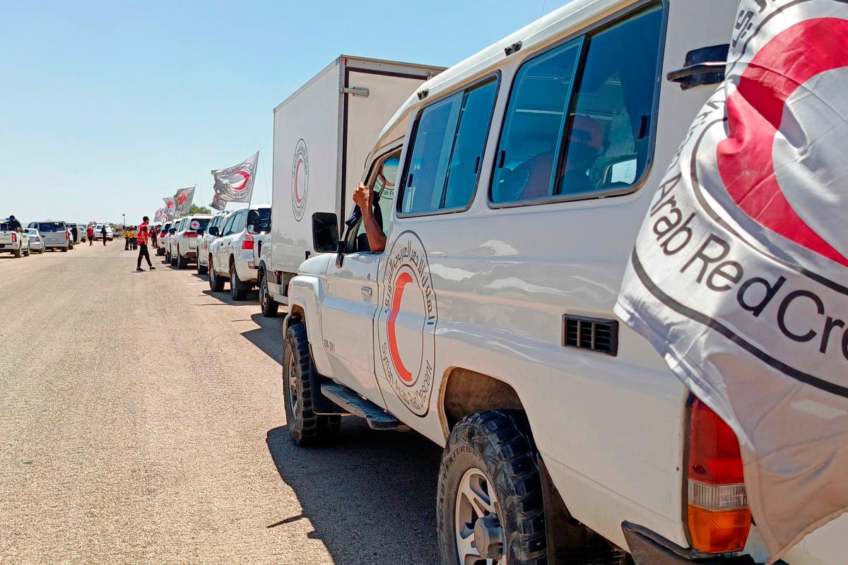 Syrian Red Crescent trucks carrying humanitarian aid arriving at Busra al-Sham in Syria’s southern Daraa province before crossing the buffer zone into Sweida province amidst a ceasefire following sectarian clashes between Druze fighters and Sunni Bedouin tribes earlier in the month. (Photo by SANA / AFP)