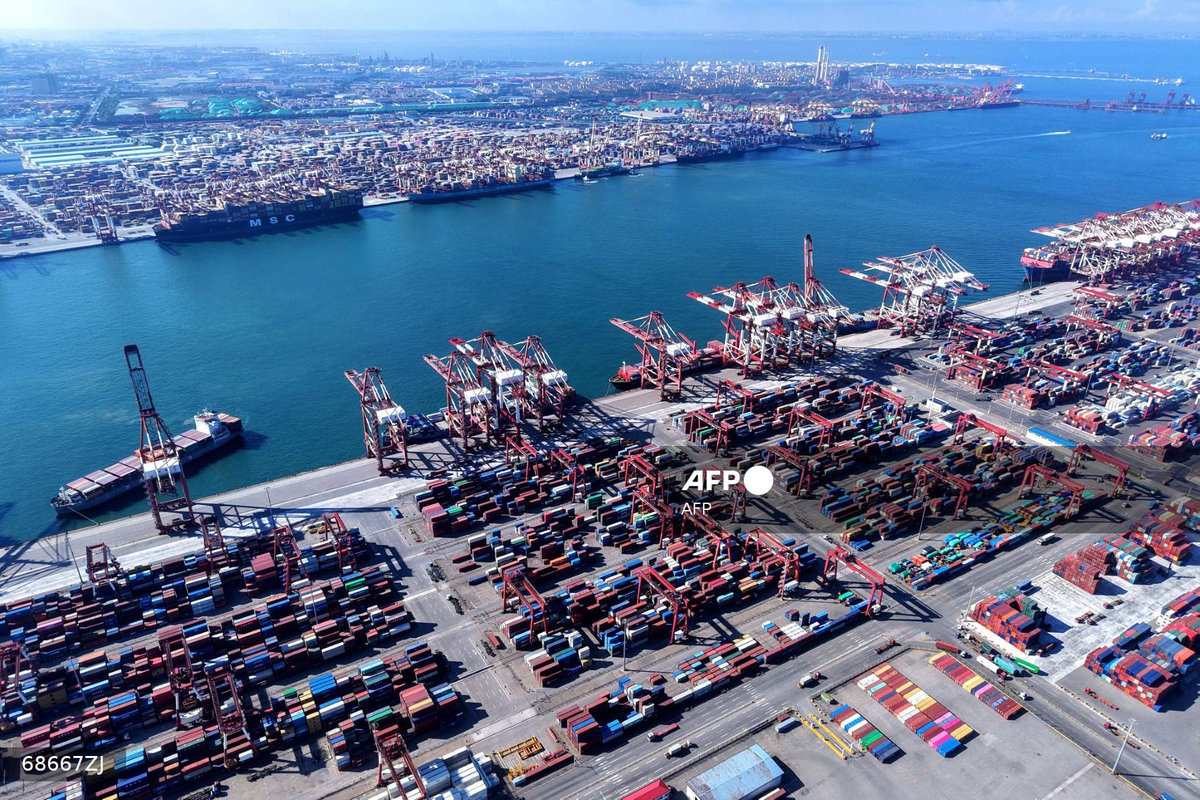 Containers and ships are seen at the port in Qingdao, in China’s eastern Shandong province on July 28, 2025. - AFP