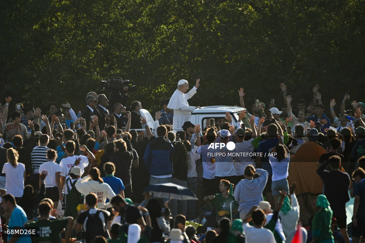 Pope Leo XIV waves as he arrives before leading a mass in the Tor Vergata district of Rome, as part of Jubilee of Youth, on August 3, 2025. Pope Leo XIV presided over a final mass in Rome for over one million young people Sunday, the culmination of a youth pilgrimage that has drawn Catholics from across the world. - AFP