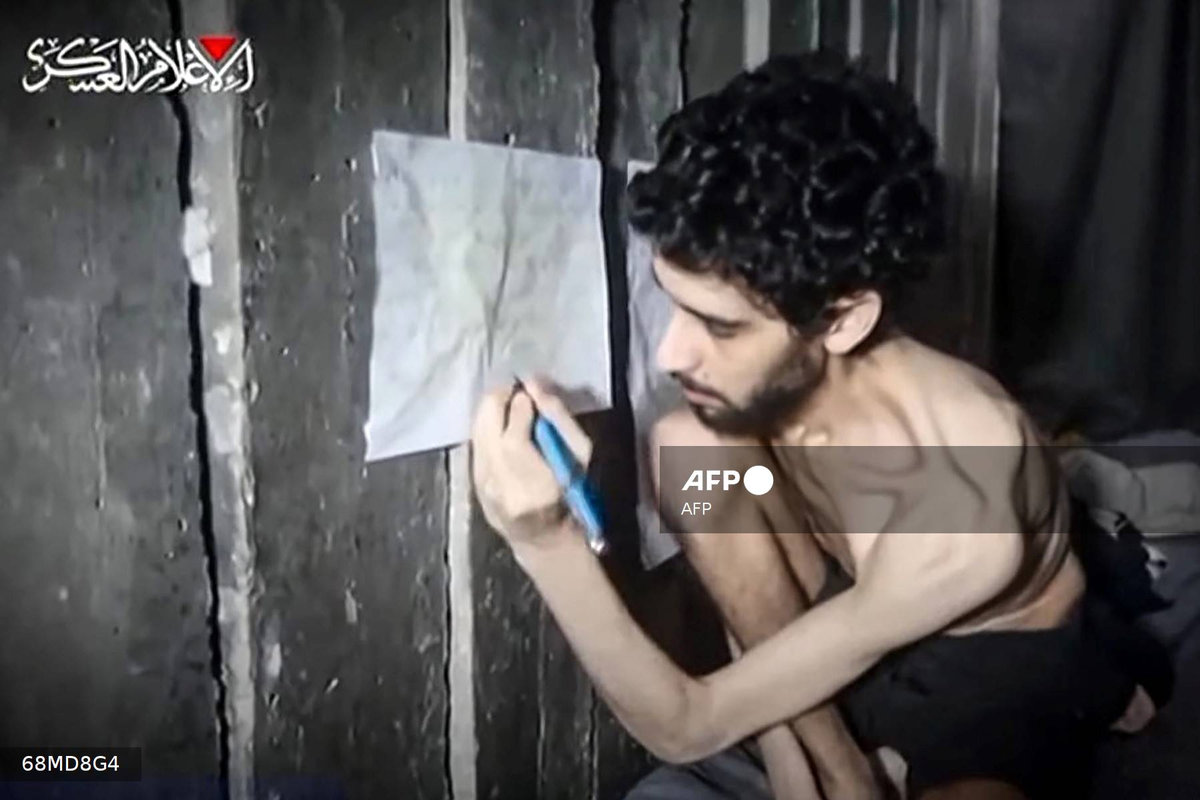 This screengrab from a video released on August 1, 2025 by the armed wing of Palestinian militant group Hamas, shows Israeli hostage Evyatar David looking weak and malnourished. David, who turned 24 in captivity, was abducted during the Hamas attack on October 7, 2023. - AFP