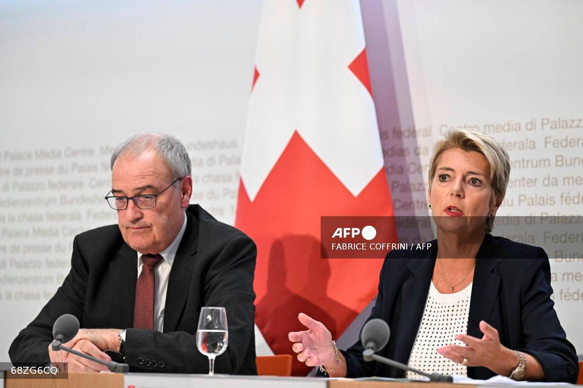 Swiss President Karin Keller-Sutter (R) speaks next to Swiss Economy Minister Guy Parmelin during a press conference following an extraordinary meeting after Swiss government failed to convince the US government not to impose 39 percent tariffs on Swiss goods, in Bern on August 7, 2025. - AFP