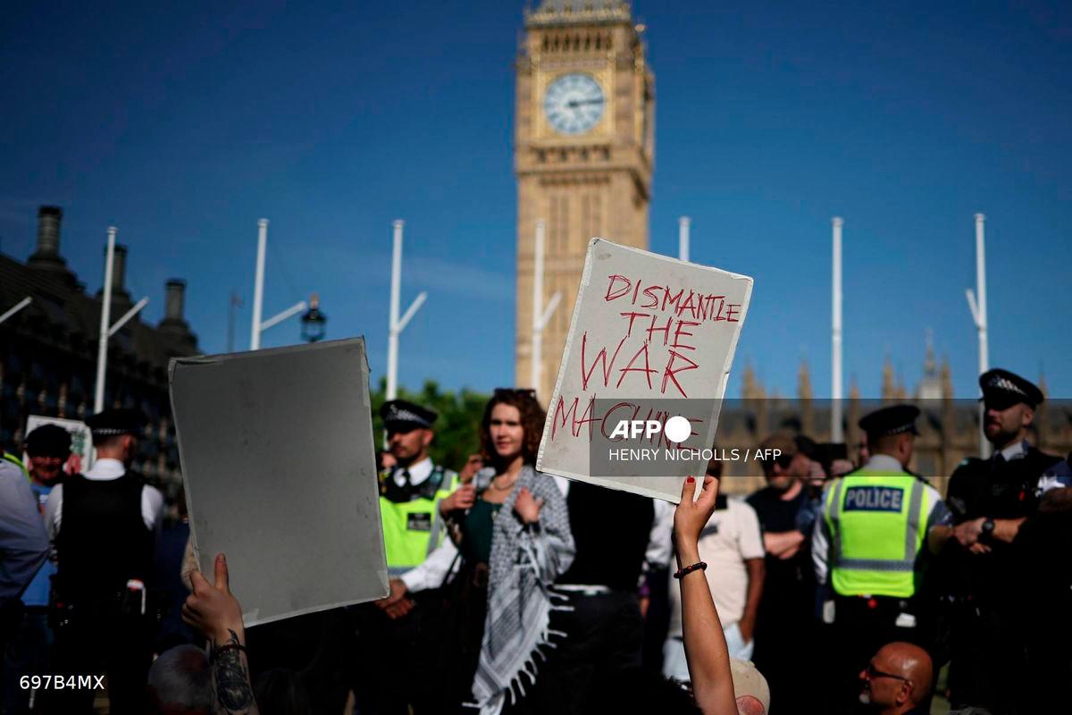Protesters hold placards at a “Lift The Ban” demonstration in support of the proscribed group Palestine Action, calling for the recently imposed ban to be lifted, in Parliament Square, central London, on August 9, 2025. (Photo by HENRY NICHOLLS / AFP)