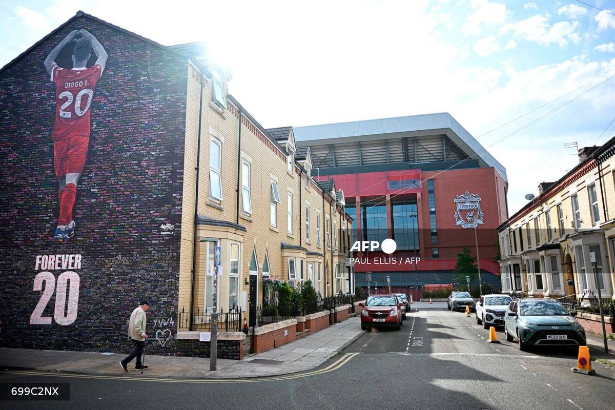 A new mural is seen on the end of a street of terraced houses, dedicated to the Portugese footballer who died in a car crash last month, created by artist Murwalls adjacent to Anfield stadium in Liverpool, north west England, on August 11, 2025. - AFP