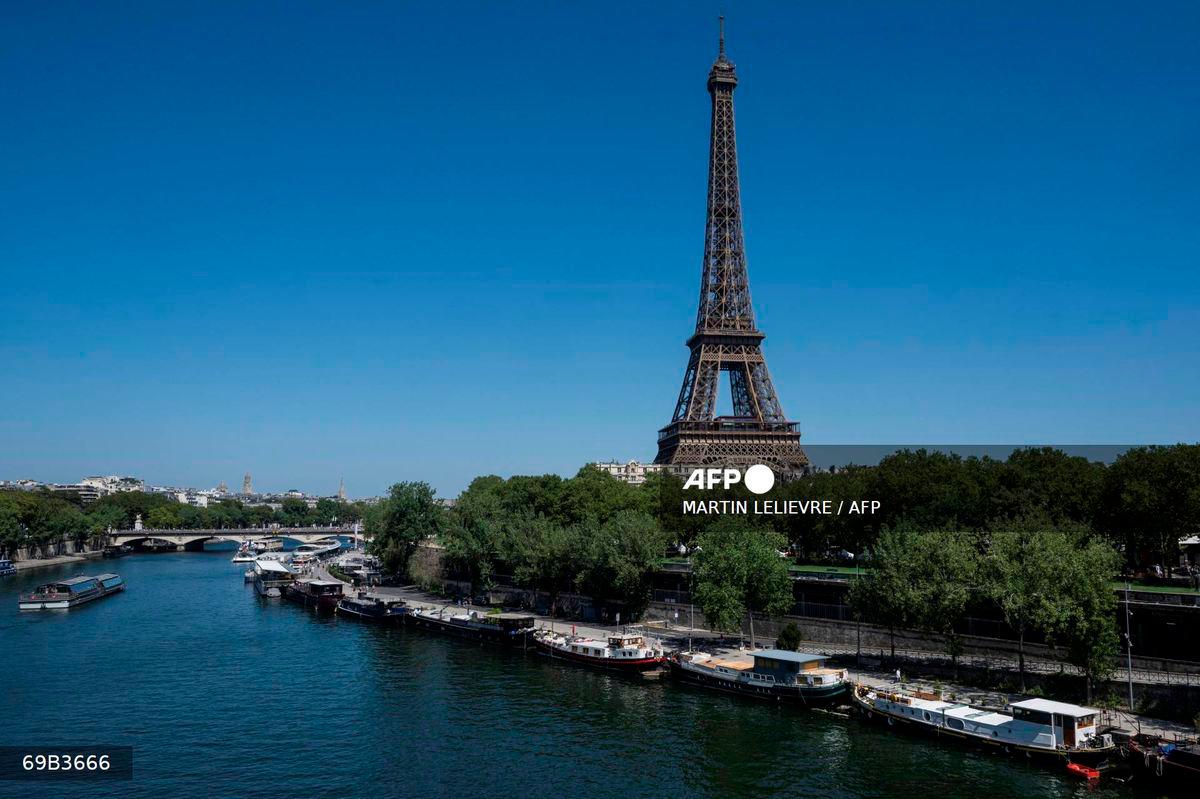 This photograph shows a view the Eiffel tower and the Seine river in Paris on August 11, 2025, amid a heatwavein Europe. - AFP