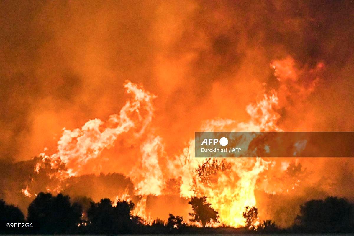 a wildfire burning a forest near the city of Patras on August 12, 2025. (Photo by EUROKINISSI / Eurokinissi / AFP)