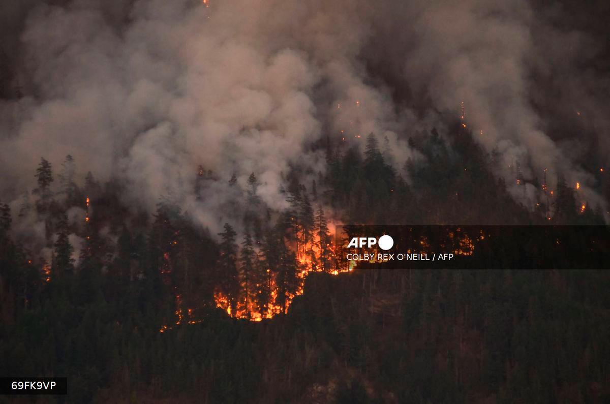 A wildfire burns on Mount Underwood near Port Alberni, on Vancouver Island, British Columbia, on August 12, 2025. - AFP
