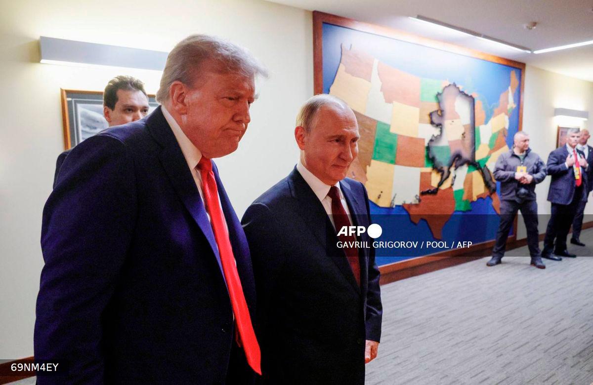 In this pool photograph distributed by the Russian state agency Sputnik, US President Donald Trump (L) and Russian President Vladimir Putin (R) walk to hold a joint press conference following a US-Russia summit on Ukraine at Joint Base Elmendorf-Richardson in Anchorage, Alaska, on August 15, 2025. - POOL via AFP